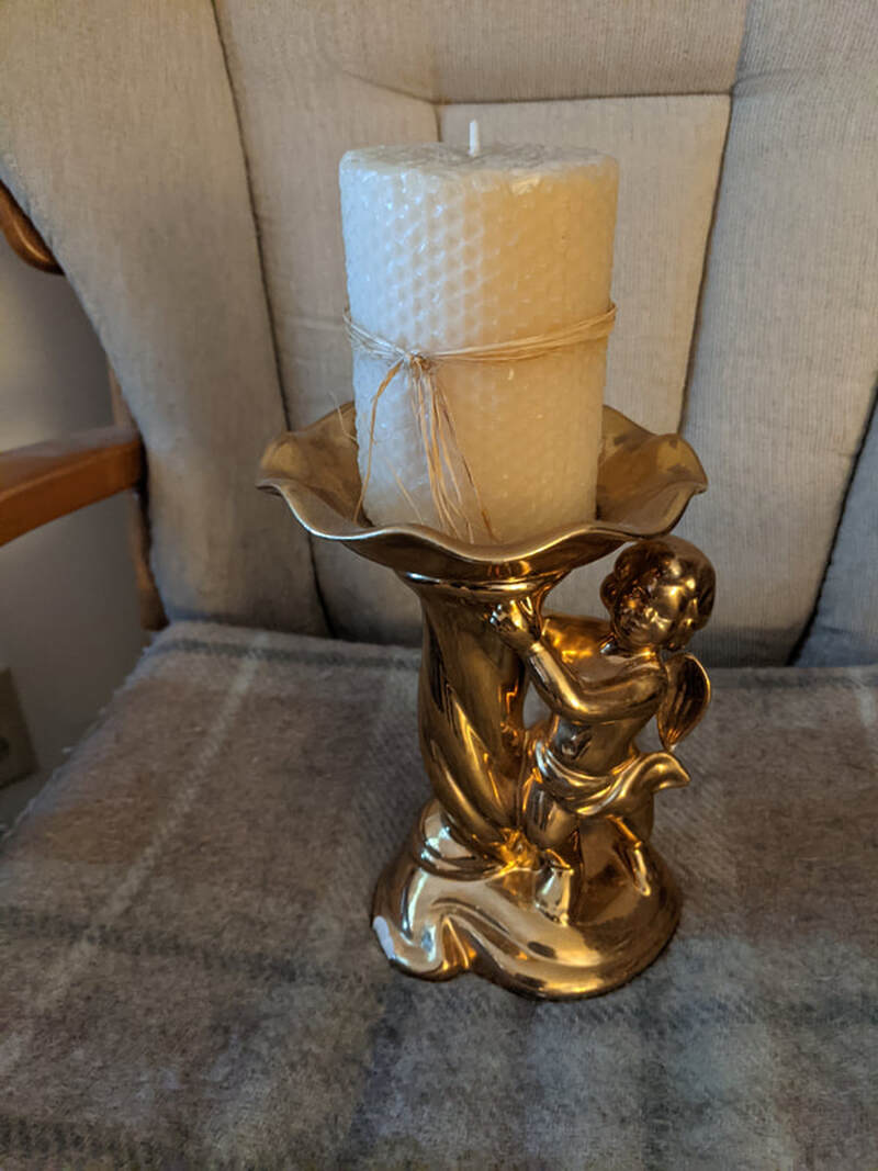 Cherub candle holder - small crack in bottom left front